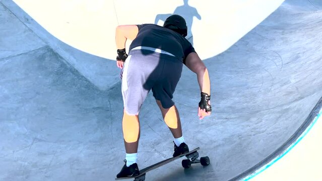 Talented young skateboarder training on the ramps of the skate park with skill and technique.