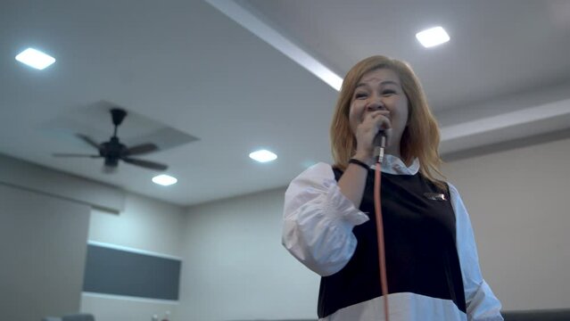 Asian Chinese Senior  singing karaoke  dancing  in living room during weekend leisure activities