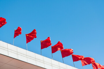 Chinese national flags waving on rooftop