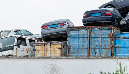 A pile of abandoned cars on junkyard