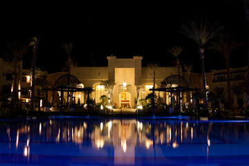 pool at night reflecting oriental palace