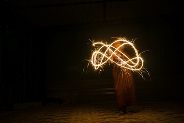 a person playing with fire crackers in the dark