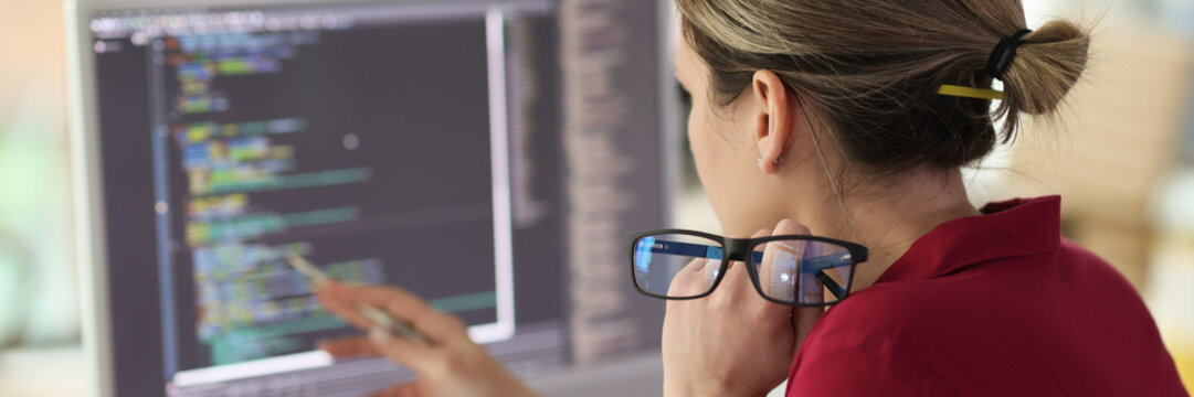 Female programmer checkups code working on computer