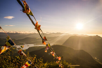 prayer flags and mountain range at golden hour sunrise