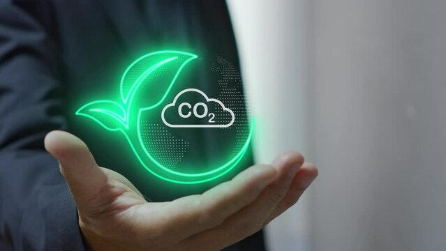 Businessman shows virtual leaf icon with CO2 icon. Net zero greenhouse gas emissions target. Reduce CO2, green business using environmentally renewable energy. change, weather concept.