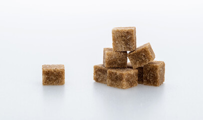 pile of brown sugar cube on white background