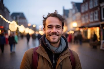 Tuinposter Handsome young man in the city at Christmas time, Holland © Nerea