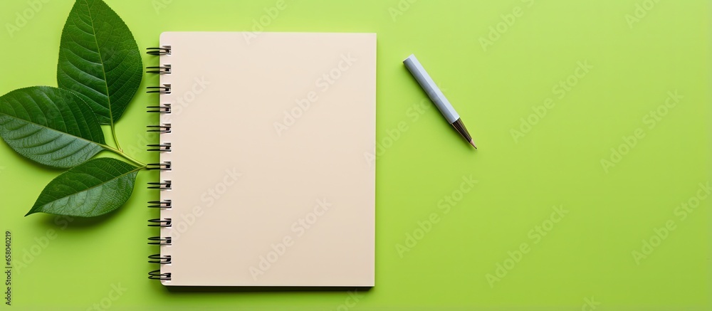 Aufkleber environmentally friendly notebook with pen and leaf on colorful background for writing