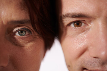 Cropped image of mature man and woman with blue and brown eyes looking at camera