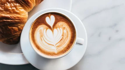 Poster A stunning overhead shot of a cappuccino with a perfect foam heart, set on a marble table with a croissant on the side, focusing on the arrangement and natural light. © Marvin