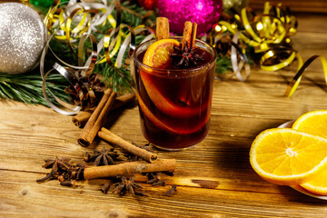 Christmas mulled wine with spices and Christmas decoration on wooden table