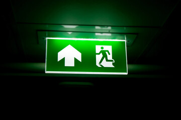 The green emergency exit - obrazy, fototapety, plakaty