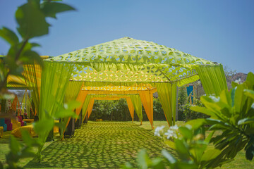 Indian wedding ceremony :stage decoration with green theme 
