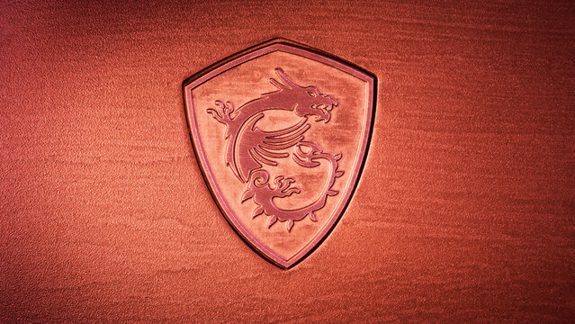 The red dragon is the logo of the Taiwanese computer hardware company MSI - Micro-Star International Co on a textured metal surface. Desktop wallpaper, 16:9. Barcelona, Spain, August 31, 2023.