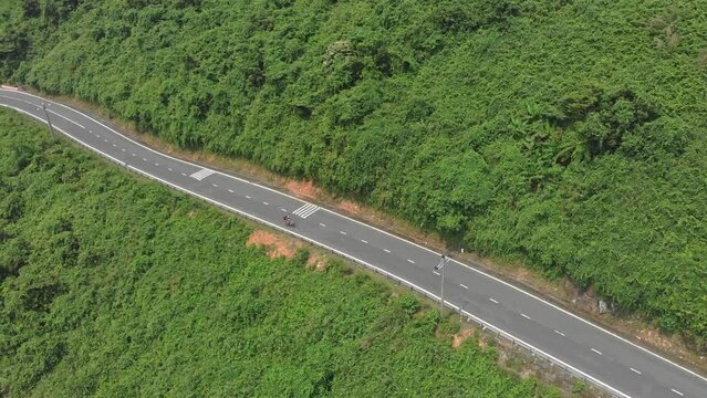 Motorbikes are driving at famous Hai van pass road at Vietnam, aerial