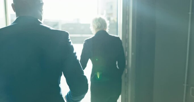 Elevator, suitcase and business people at airport, hotel and ceo travel together. Luggage, back and senior man and woman walking outdoor to exit after flight, journey and holiday, vacation or trip