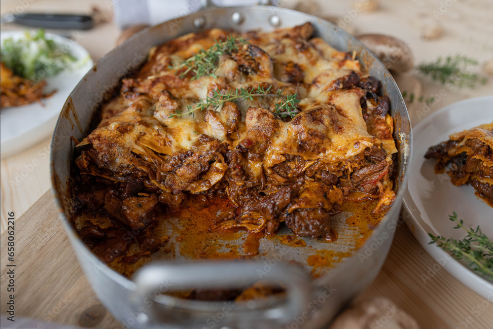 Wall mural homemade lasagna with turkey meat leftovers, mushrooms and cheese in a roasting pan