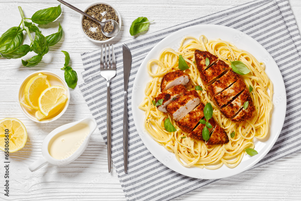 Wall mural crusted chicken over lemon butter pasta, top view