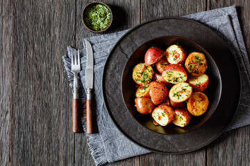 Herbs Garlic Potatoes in black bowl, top view