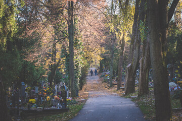 All Saints Day in cemetery in nostalgic autumnal time
