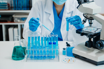 Modern medical research laboratory. female scientist working with micro pipettes analyzing...