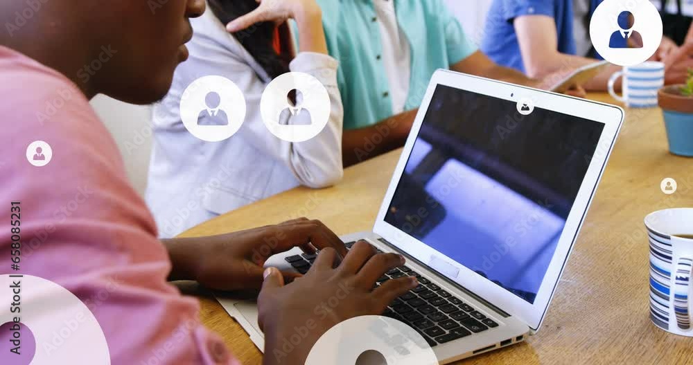 Poster animation of multiple profile icons over diverse coworkers discussing and working on laptop