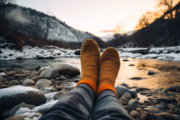 Thermal socks hanging outside a camping tent in a winter landscape, essential for keeping feet warm...