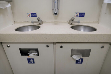 Both of steel sink in a modern toilet of the Thai new express train.