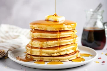 Foto op Plexiglas a stack of fluffy pancakes with maple syrup drizzle © altitudevisual