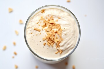 a view of peanut butter milkshake from above on a white tablecloth