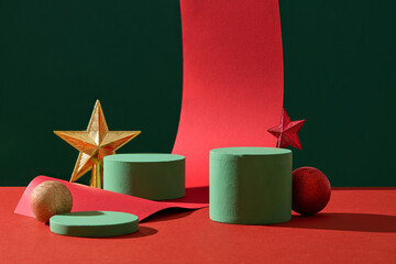 A set of green podiums arranged on the red surface with stars and baubles. Empty space on the...