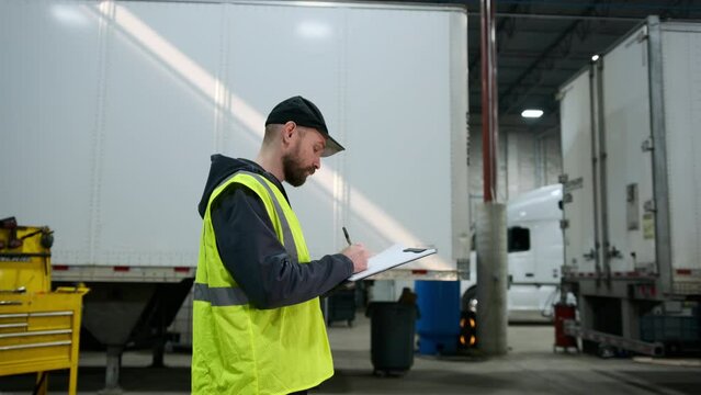 Service of the truck in the technical center or warehouse, records information about the truck. Wide shot view. move camera