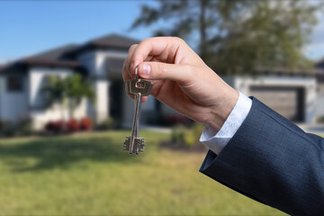 Man hand holding on finger keys to new house.