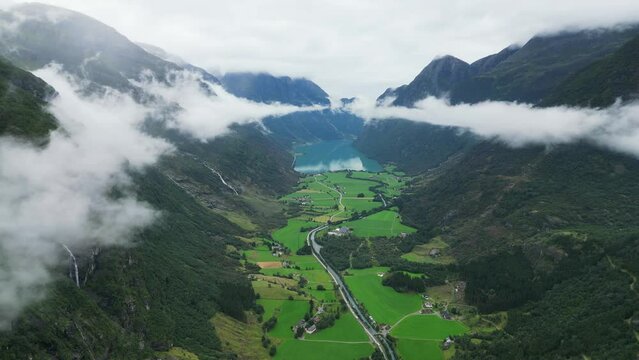 Oldevatnet Lake and Green Valley Mountains Clouds in Stryn, Vestland, Norway - Aerial