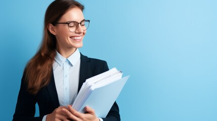 woman accountant stands in profile and holds documents