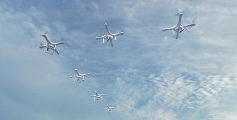 A group of drones forms a flock similar to a flock of migratory birds. This image can be used to represent the idea of drones working together in a coordinated manner. 3D Illustration.