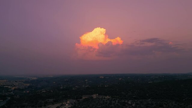 Aerial shot of last lights on the cloud painting it in carrot orange color