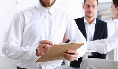 Male arm in shirt hold silver pen and pad making note in office closeup. Deal consult delivery...