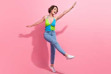 Fototapeta na wymiar Full length cadre of carefree drunk young lady dance boogie woogie hands wings positive rhythm clubbing isolated on pink color background