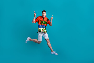 Full body photo of overjoyed positive friendly macho showing double v sign greetings tropical print...