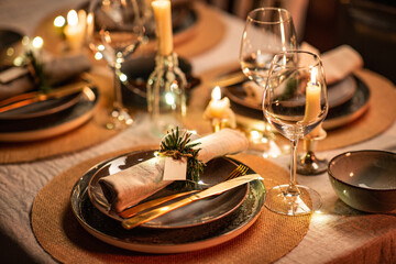 winter holidays, dinner party and celebration concept - close up of scandinavian christmas table serving with burning candles at home at night - 658131073