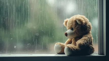 Fotobehang teddy bear on a rainy window © The Stock Photo Girl