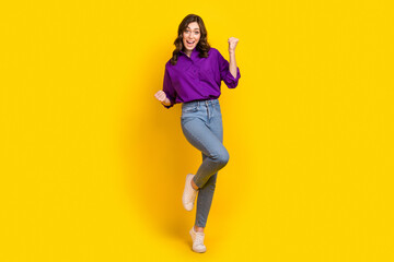 Fototapeta na wymiar Full length portrait of overjoyed satisfied person raise fists triumph accomplishment isolated on yellow color background