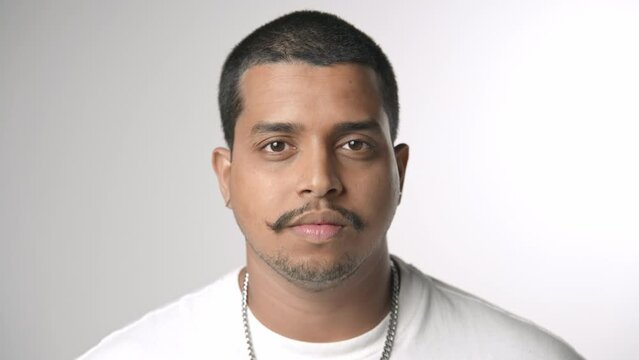 Handsome person look at camera close up. Young adult man face portrait. Stylish 30 years old guy on isolated white background. Attractive male model. Modern millennial people. Brutal style barber shop