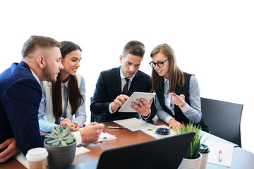Young handsome man gesturing and discussing something while his coworkers listening to him sitting at the office table on a transparent background