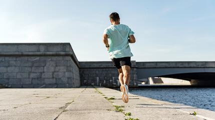A runner doing intense exercises, uses a fitness tracker. Instructor marathon preparation, athletic...