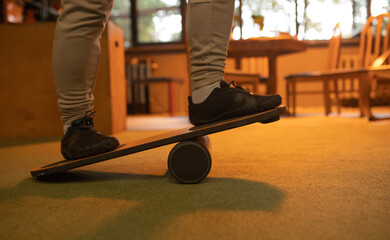 Balance board, close up view with athlete feet. Athlete training with balance board for sports such...