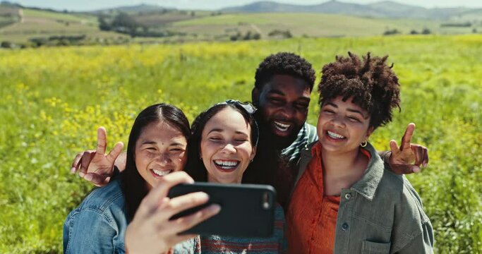 Selfie, friends and peace sign with a group of young people outdoor in nature together for freedom. Phone, smile or love with happy men and women posing for a profile picture in field at countryside