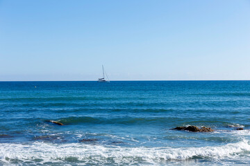 Sea with blue sunny sky and waves in Mijas, Andalusia, Spain