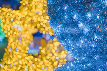 Merry Christmas and New Year web banner, blurred background of bright yellow and blue garlands